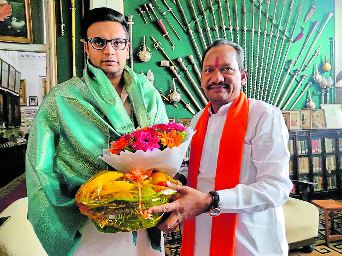 Minister for Animal Husbandry Prabhu Chauhan greets scion of the erstwhile royal family of Mysuru Yaduveer Krishnadatta Chamaraja Wadiyar on Wednesday. DH PHOTO