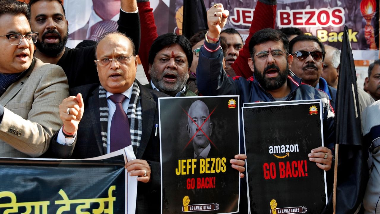 Members of the Confederation of All India Traders (CAIT) hold placards and shout slogans during a protest against the visit of Jeff Bezos, founder of Amazon, to India, in New Delhi, India, January 15, 2020. Credit: Reuters Photo