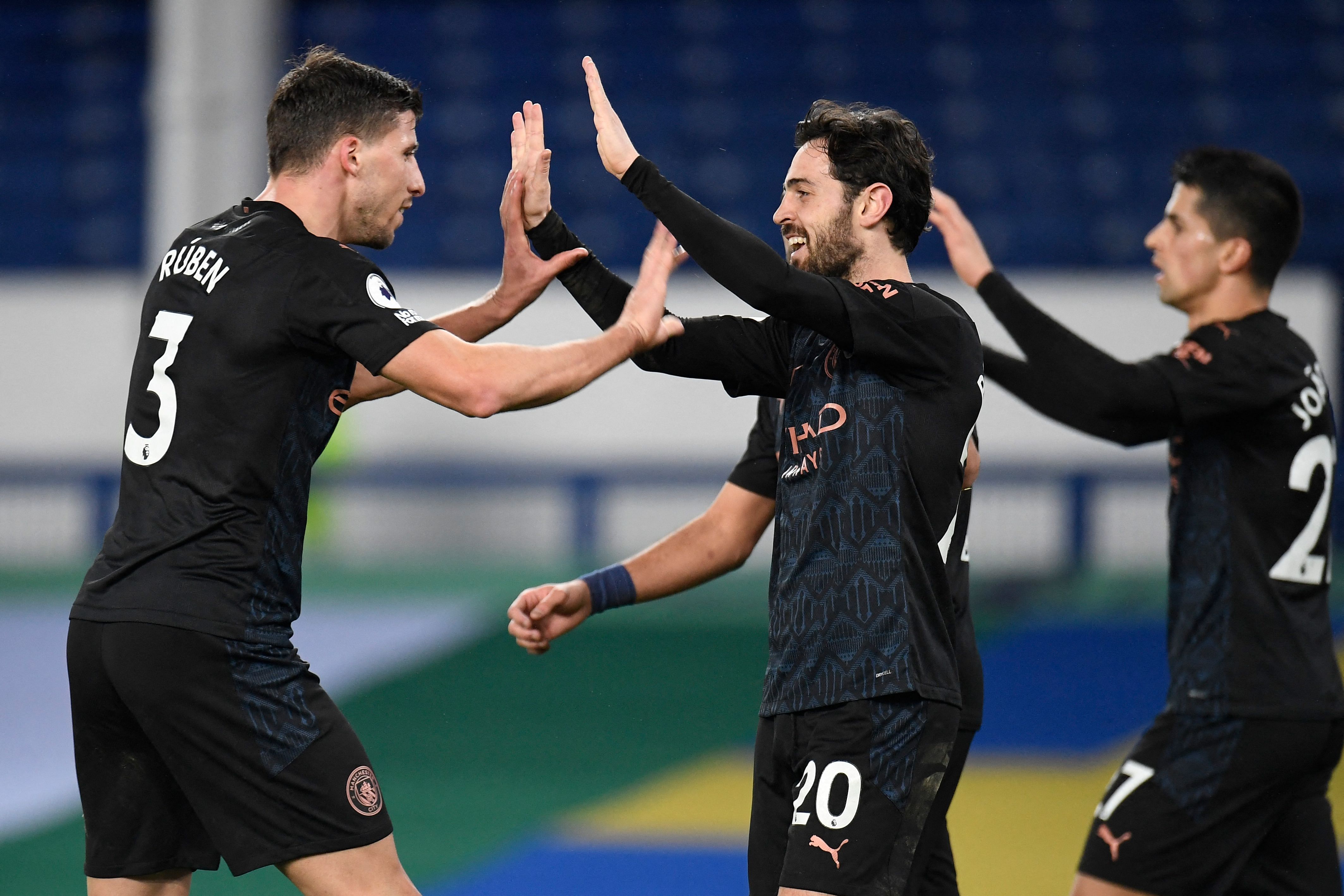 Manchester City's Portuguese midfielder Bernardo Silva (C) celebrates with teammates after scoring his team's third goal during the English Premier League. Credit: AFP Photo