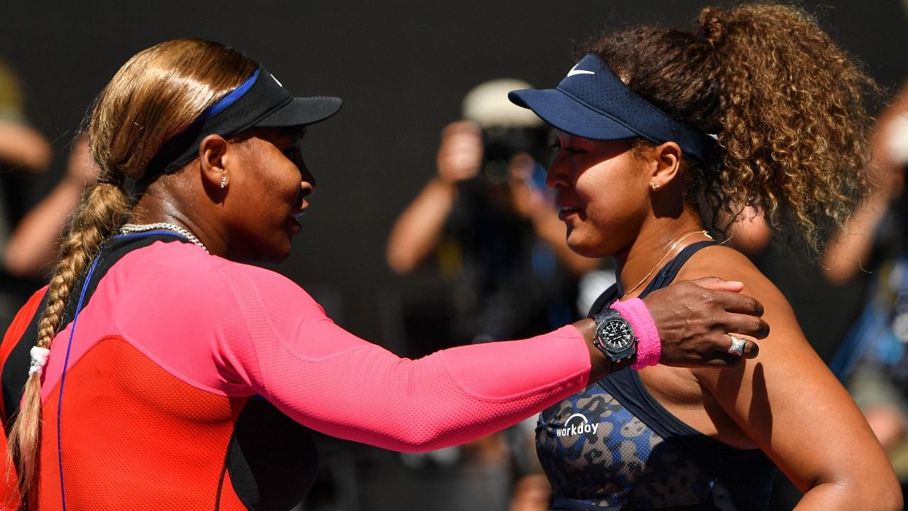 Serena Williams of the US (L) congratulates Japan's Naomi Osaka on her win in their women's singles semi-final match on day eleven of the Australian Open tennis tournament in Melbourne on February 18, 2021. Credit: AFP Photo