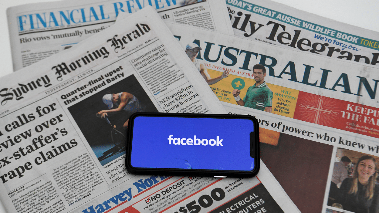 An illustration image shows a phone screen with the 'Facebook' logo and Australian newspapers in Canberra. Credit: Reuters Photo