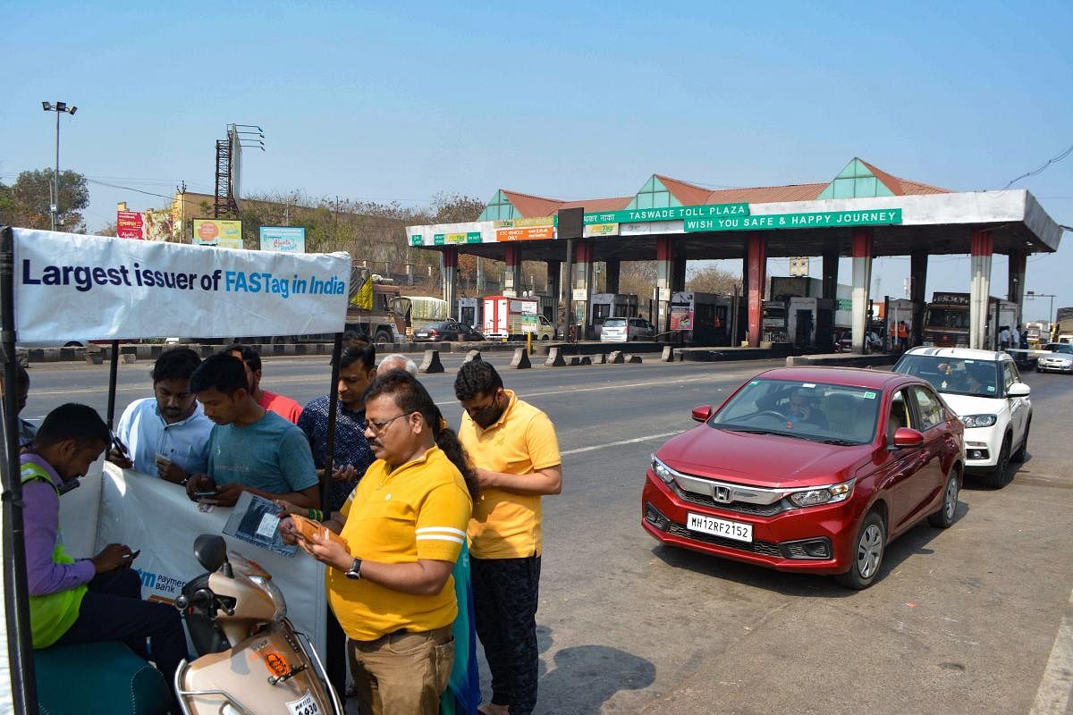 People register for FASTag at a Taswade toll plaza on the Pune-Bangalore national highway, in Karad. Credit: PTI photo. 