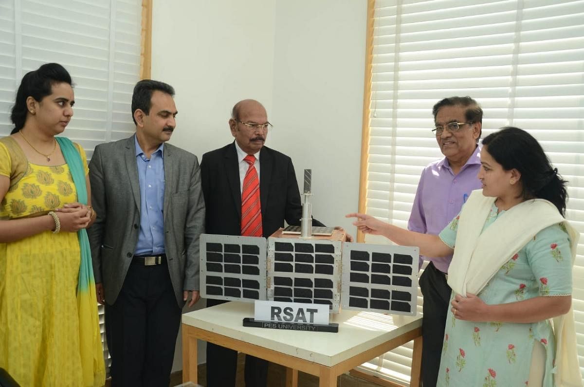 Prof M R Doreswamy, Chancellor, PES University, and faculty members display the RSAT microsatellite to be launched on February 28. SPECIAL ARRANGEMENT