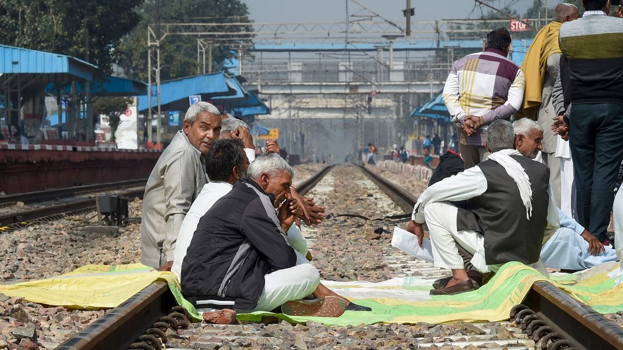 Members of various farmer organisations block a railway track during a four-hour 'rail roko' demonstration across the country, called by Samyukta Kisan Morcha (SKM), as part of their agitation against Centre's farm reform laws, in Sonipat district. Credit: PTI Photo