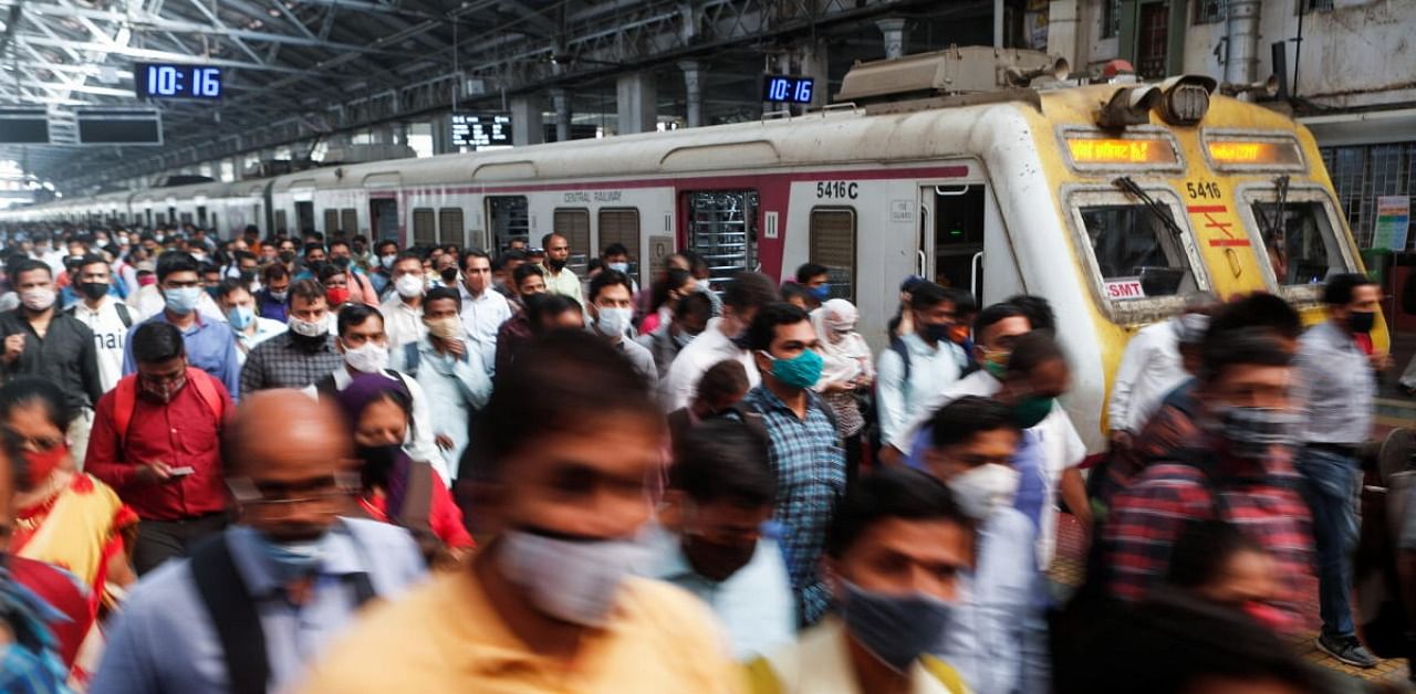 Commuters walk on a railway platform after disembarking from a train amidst the spread of the coronavirus disease in Mumbai, India, February 9, 2021. Credit: Reuters Photo