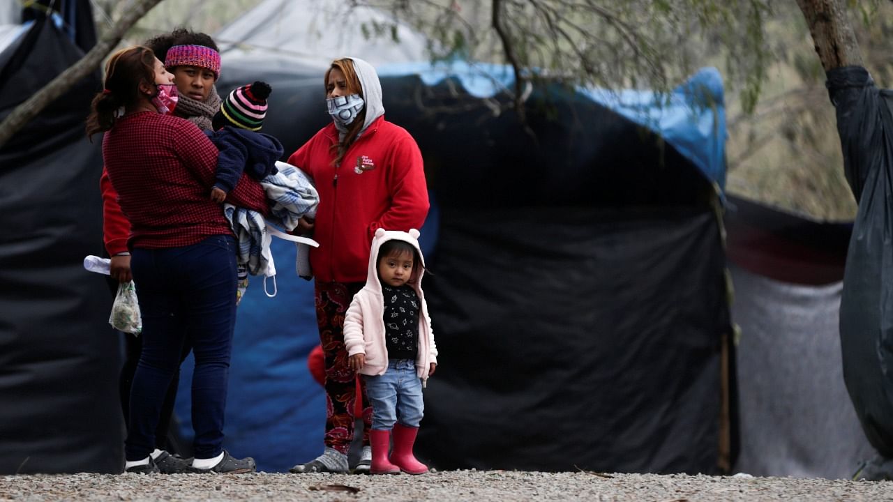 Asylum seekers stand inside a migrant encampment in Matamoros, Mexico. Credit: Reuters File Photo