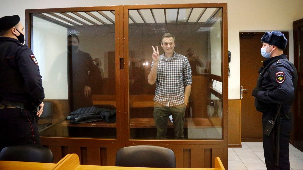 Opposition leader Alexei Navalny stands in a cage in the Babuskinsky District Court in Moscow, Russia. Credit: AP/PTI Photo