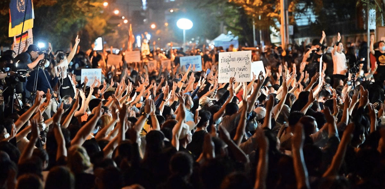 Pro-democracy protesters hold up the three finger salute as they take part in an anti-government rally near the Thai Parliament in Bangkok. Credit: AFP Photo
