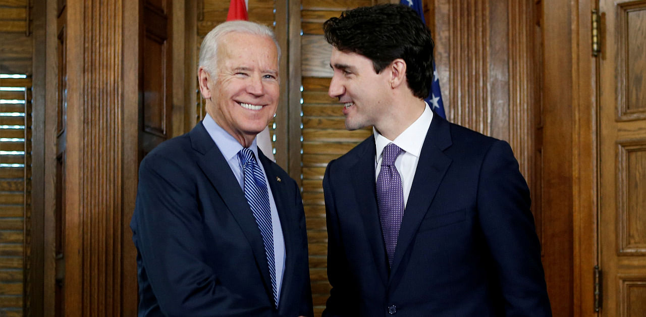 Canada's prime minister, Justin Trudeau (R), shakes hands with then-U.S. Vice President Joe Biden during a meeting in Trudeau's office. Credit: Reuters Photo