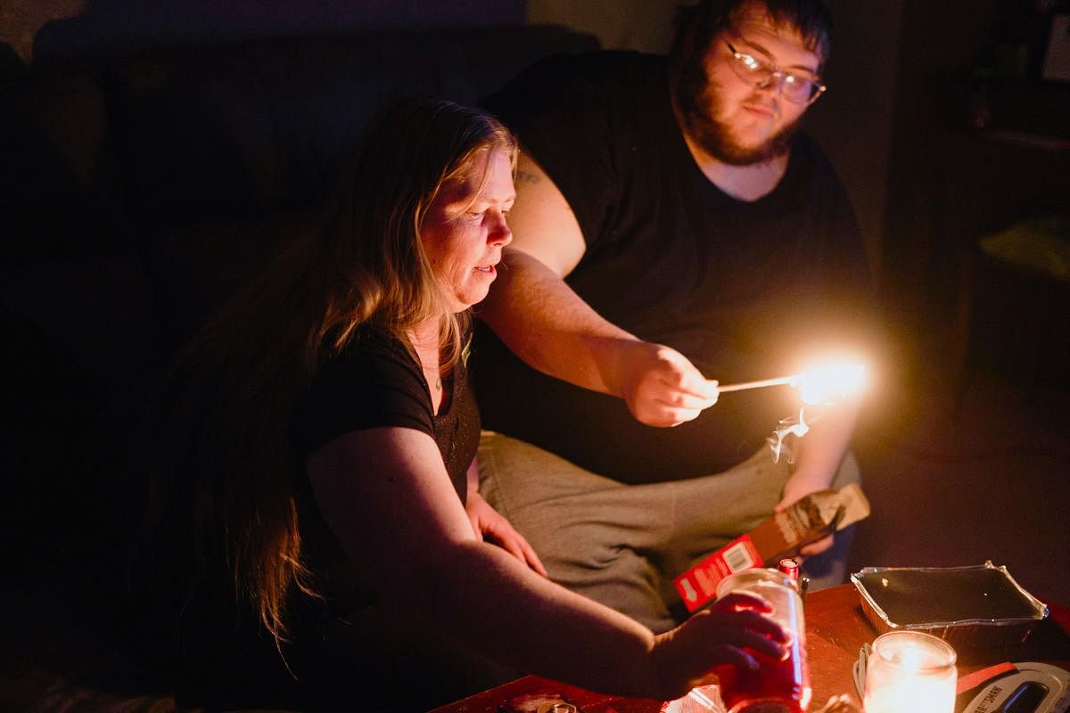 Christina Beverly and John Shearon light candles in their home after winter weather caused electricity blackouts and "boil water" notices in Fort Worth, Texas, U.S. February 20, 2021. Their home has not had power since blackouts began across the state on Sunday, February 14, 2021, according to the residents. Credit: REUTERS
