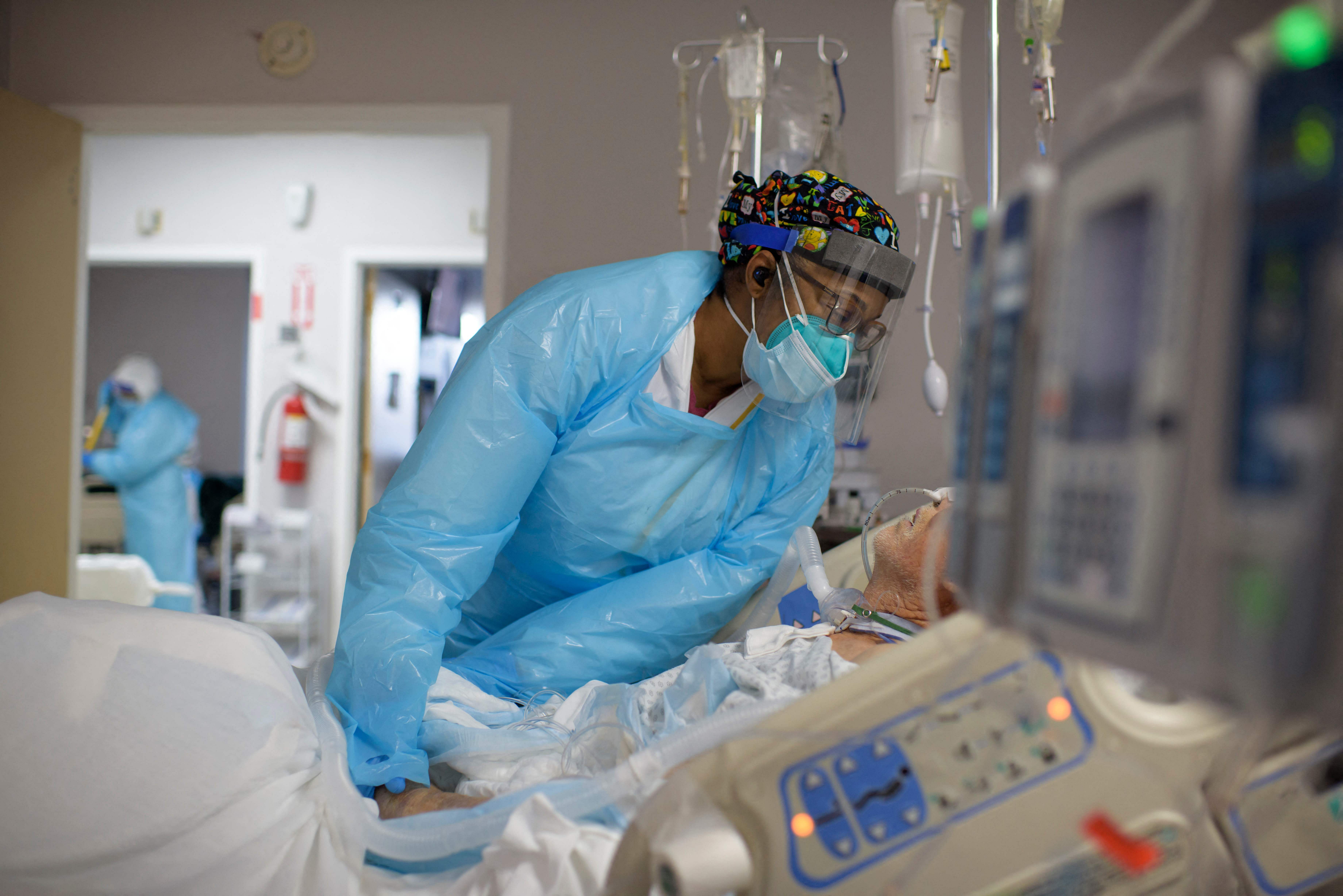 Healthcare worker Demetra Ransom comforts a patient in the Covid-19 ward. Credit: AFP Photo