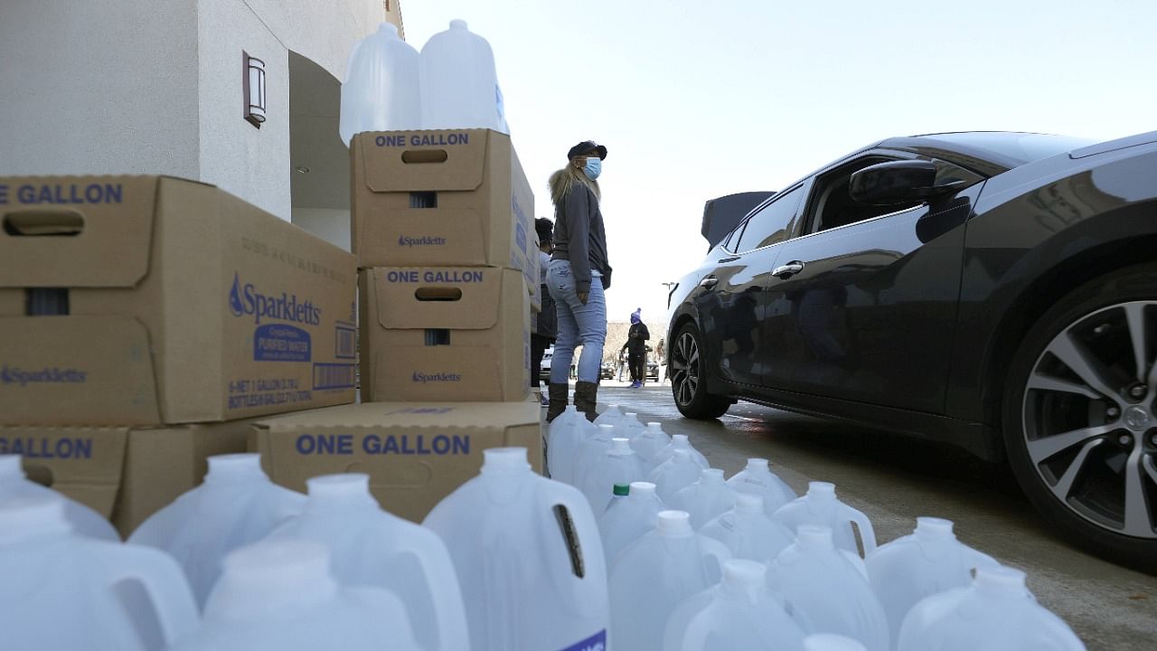 Volunteers prepare to had out water during a water distribution event at the Fountain Life Center on February 20, 2021 in Houston, Texas. Credit: AFP Photo