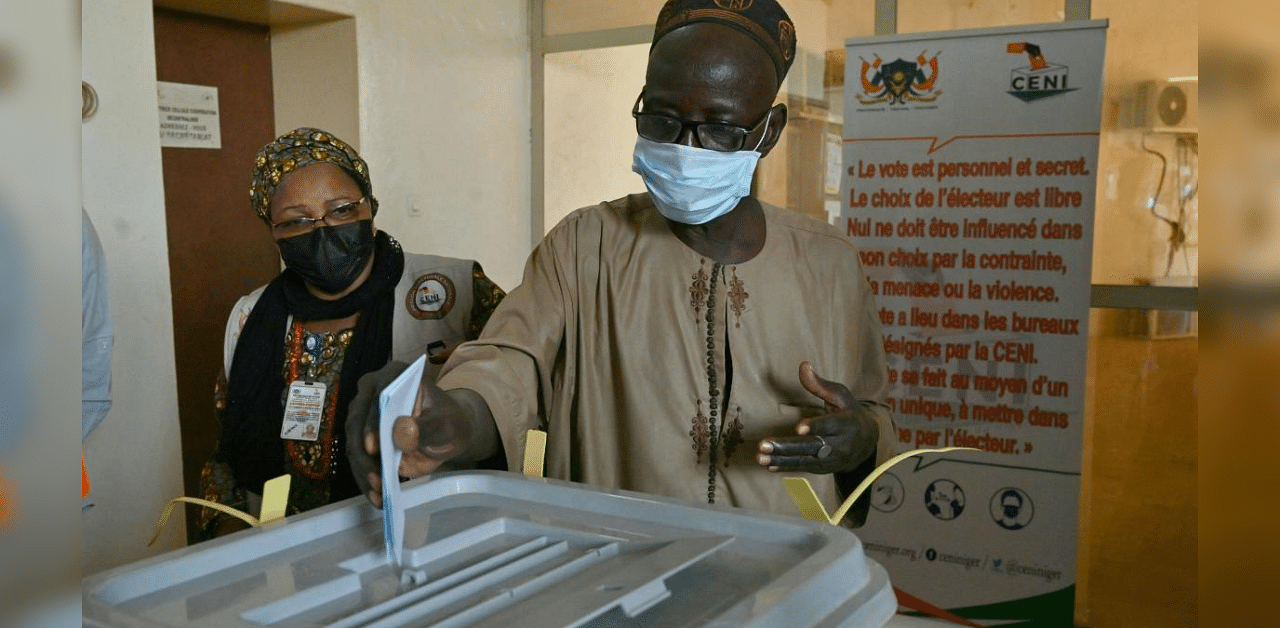 A man casts his vote at the polling station during Niger's presidential election run-off, in Niamey. Credit: AFP Photo