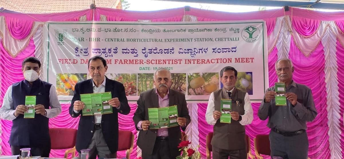 Dignitaries release a handbook during a field demonstration and interaction with scientists, organised jointly by the Indian Institute of Horticultural Research and Central Horticultural Experiment Station in Chettalli.