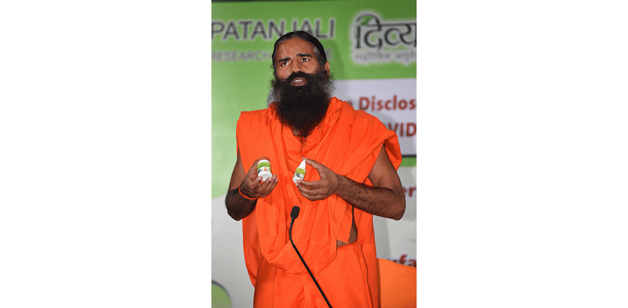 Yoga guru Ramdev addresses the media during the launch of 'Coronil' and 'Swasari', ayurvedic medicines. Credit: PTI Photo