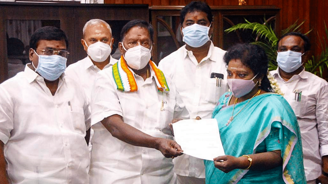 Puducherry Chief Minister V Narayanasamy hands over his resignation letter to Lt Governor Dr Tamilisai Soundararajan after he failed to prove his majority in the assembly, in Puducherry. Credit: PTI Photo