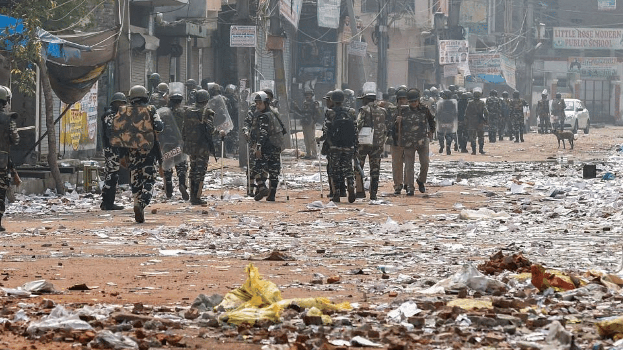  Security personnel conduct patrolling as they walk past Bhagirathi Vihar area of the riot-affected north east Delhi, Wednesday, Feb. 26, 2020. Credit: PTI Photo