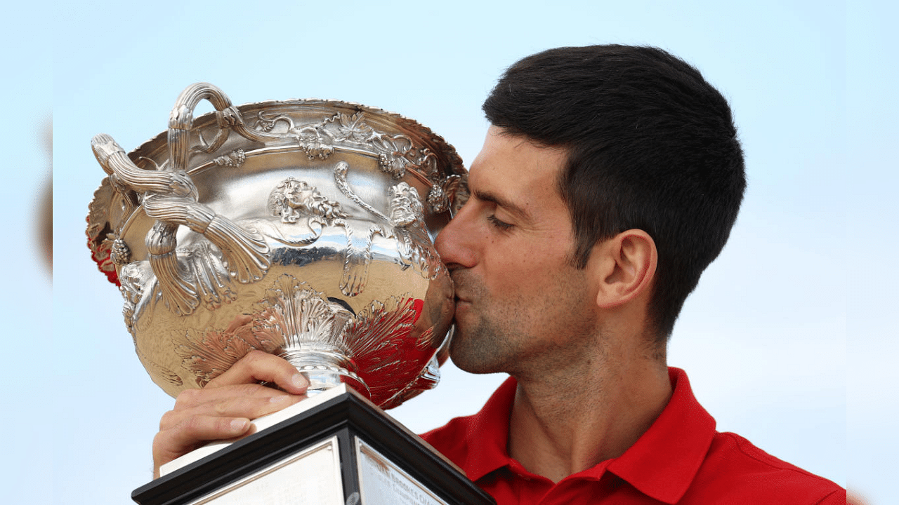  Australian Open champion Serbia's Novak Djokovic poses with the trophy during a photo shoot at Brighton Beach. Credit: Reuters Photo