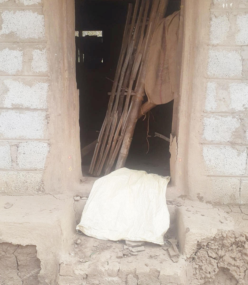 The damaged door of a house at Chennangi Basavanahalli Haadi in Chennayyanakote Gram Panchayat.