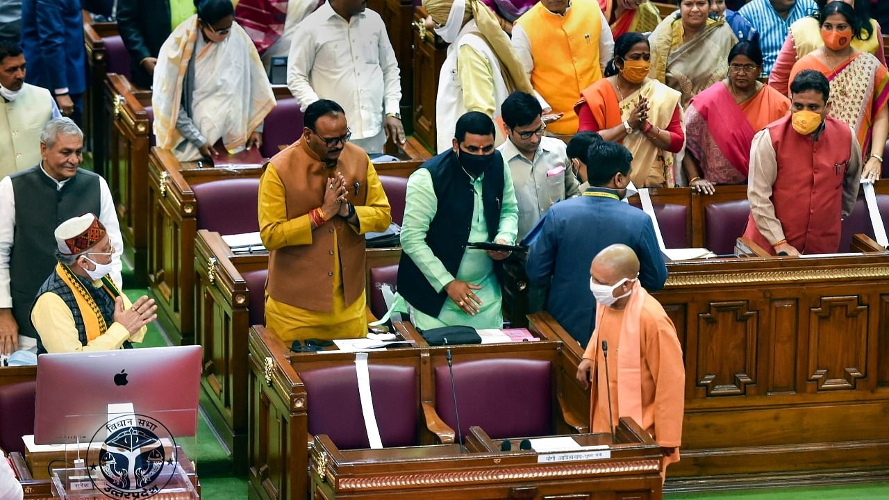 Uttar Pradesh Chief Minister Yogi Adityanath being greeted by state Finance Minister Suresh Khanna before he presents the paperless State Budget 2021-22 in the UP Legislative Assembly, in Lucknow. Credit: PTI Photo