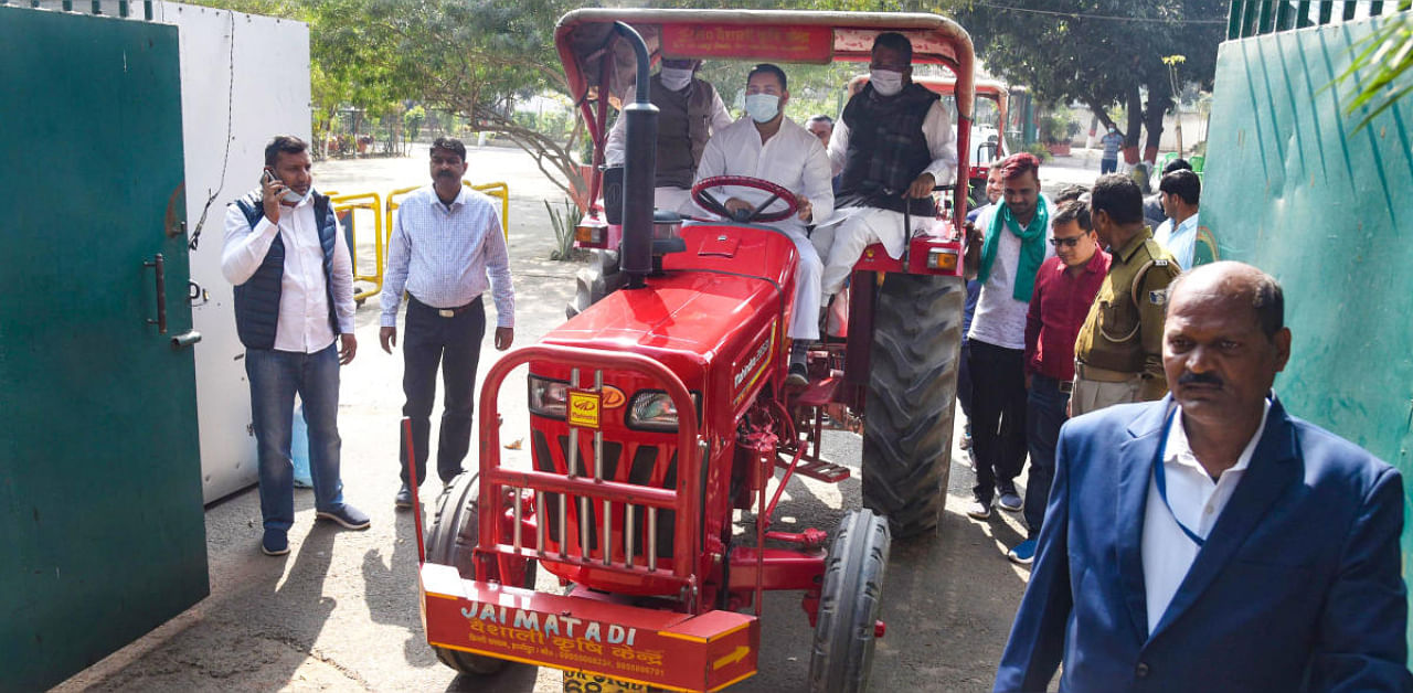 RJD leader Tejashwi Yadav rides a tractor during a protest against the new farm laws amid the Budget Session of Bihar Assembly, in Patna. Credit: PTI photo. 