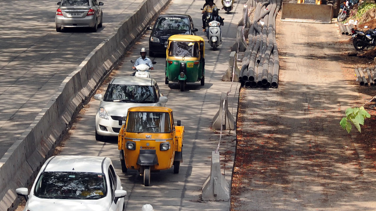 Commuters use a part of the road as the whitetopping work takes place at CV Raman Road in Bengaluru. Credit: DH File Photo