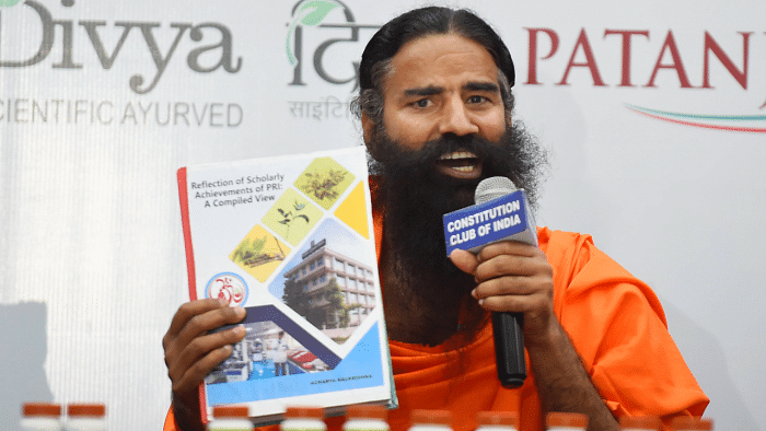 Baba Ramdev releases the scientific research papers on the Patanali medicine for Covid-19. Credit: PTI Photo