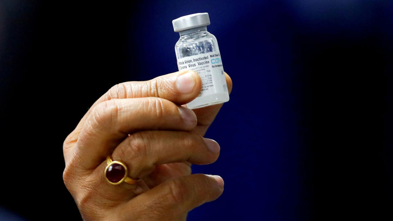 Health Minister Harsh Vardhan holds a dose of Bharat Biotech's Covid-19 vaccine called Covaxin. Credit: Reuters file photo
