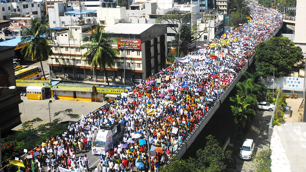 Members of the Karnataka Private School Managements, Teaching and Non-Teaching Staff Coordination Committee (KPMTCC) take part in a protest rally against the state government's order for private schools to charge only 70% of the tuition fees in this academic year, in Bengaluru. Credit: PTI Photo