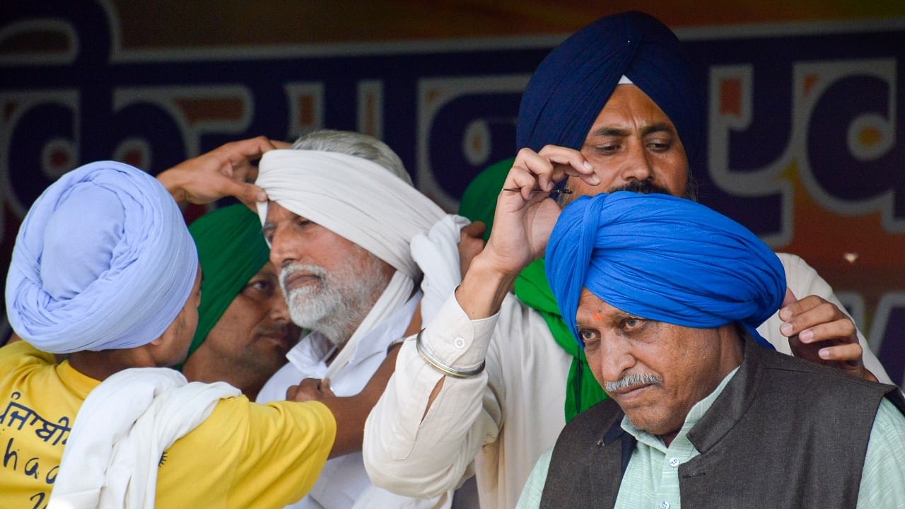 Farmers wear turbans during an agitation against the new farm laws and observe ‘Pagdi Sambhal Jatta’ day in the memory of Sardar Ajit Singh on his birth anniversary, at Ghazipur border in New Delhi. Credit: PTI Photo