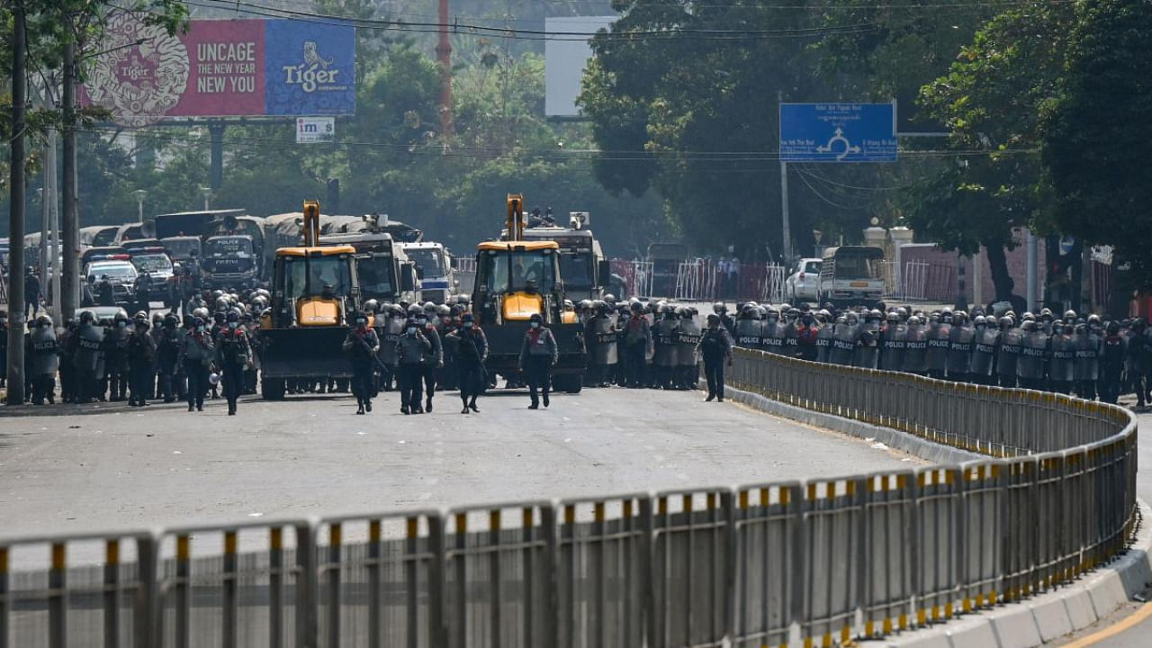 Police advance with heavy construction equipment towards protesters demonstrating against the military coup in Yangon on February 22, 2021. Credit: AFP.