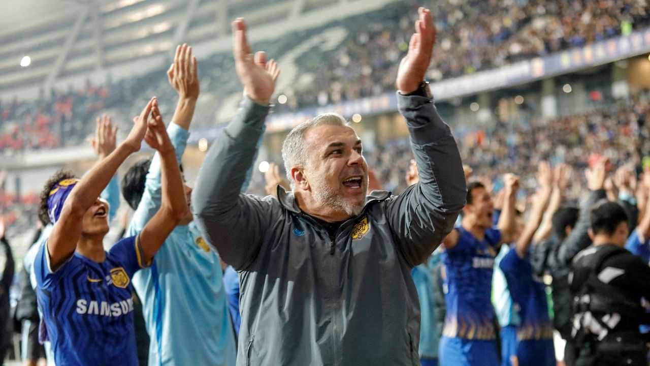 This file photo taken on November 12, 2020 shows Jiangsu Suning's head coach Cosmin Olaroiu (C) celebrating after their team defeated Guangzhou Evergrande to win the Chinese Super League (CSL) football championship in Suzhou in China's eastern Jiangsu province. Credit: AFP Photo