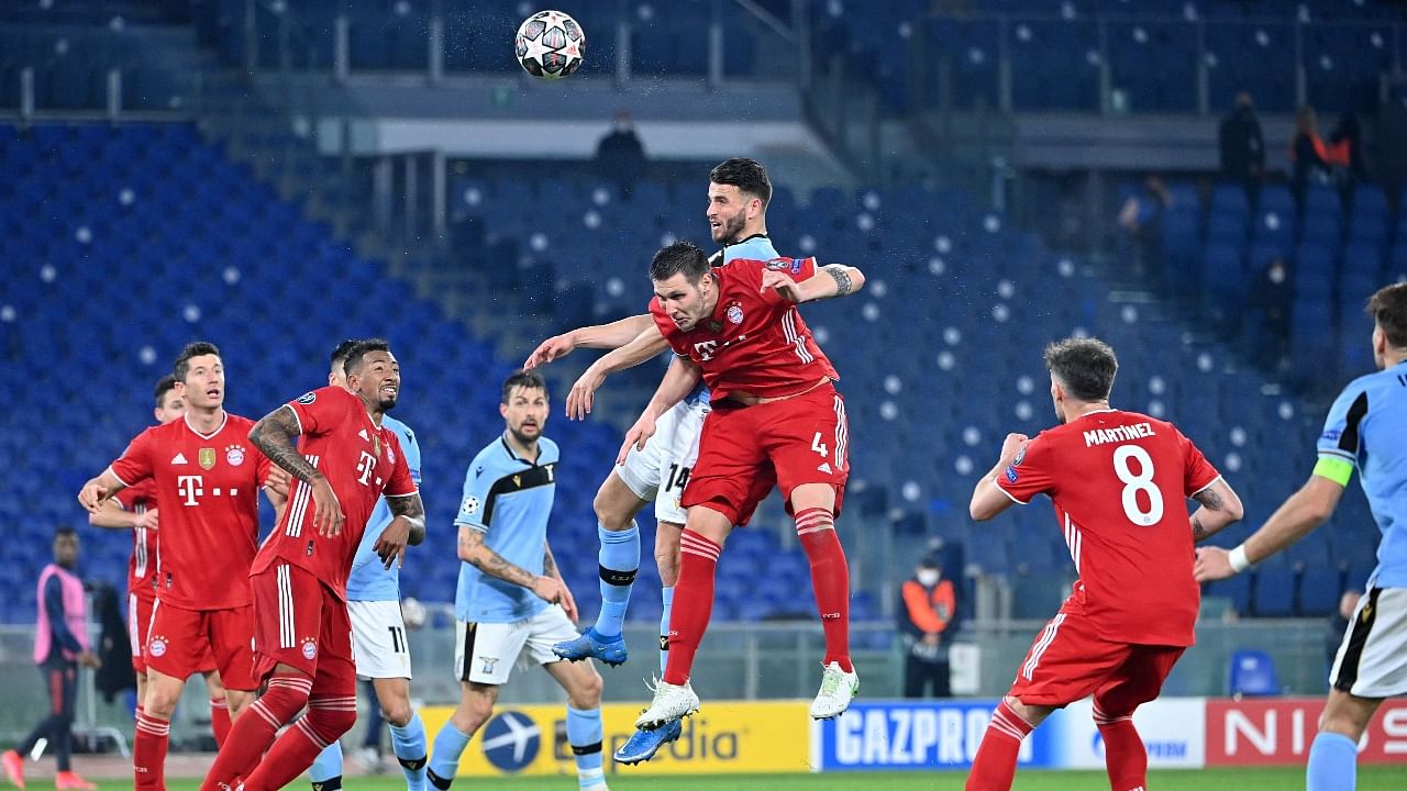 Bayern Munich's German defender Niklas Suele (C) go for a header during the UEFA Champions League round of 16 first leg football match Lazio Rome vs Bayern Munich on February 23, 2021 at the Olympic stadium in Rome. Credit: AFP Photo