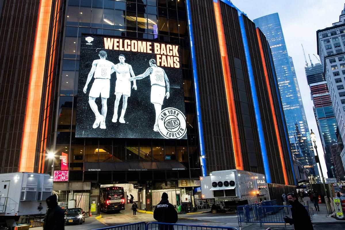 People walk outside Madison Square Garden before a Knicks game amid the coronavirus disease in the Manhattan borough of New York City, New York, US. Credit: Reuters photo. 