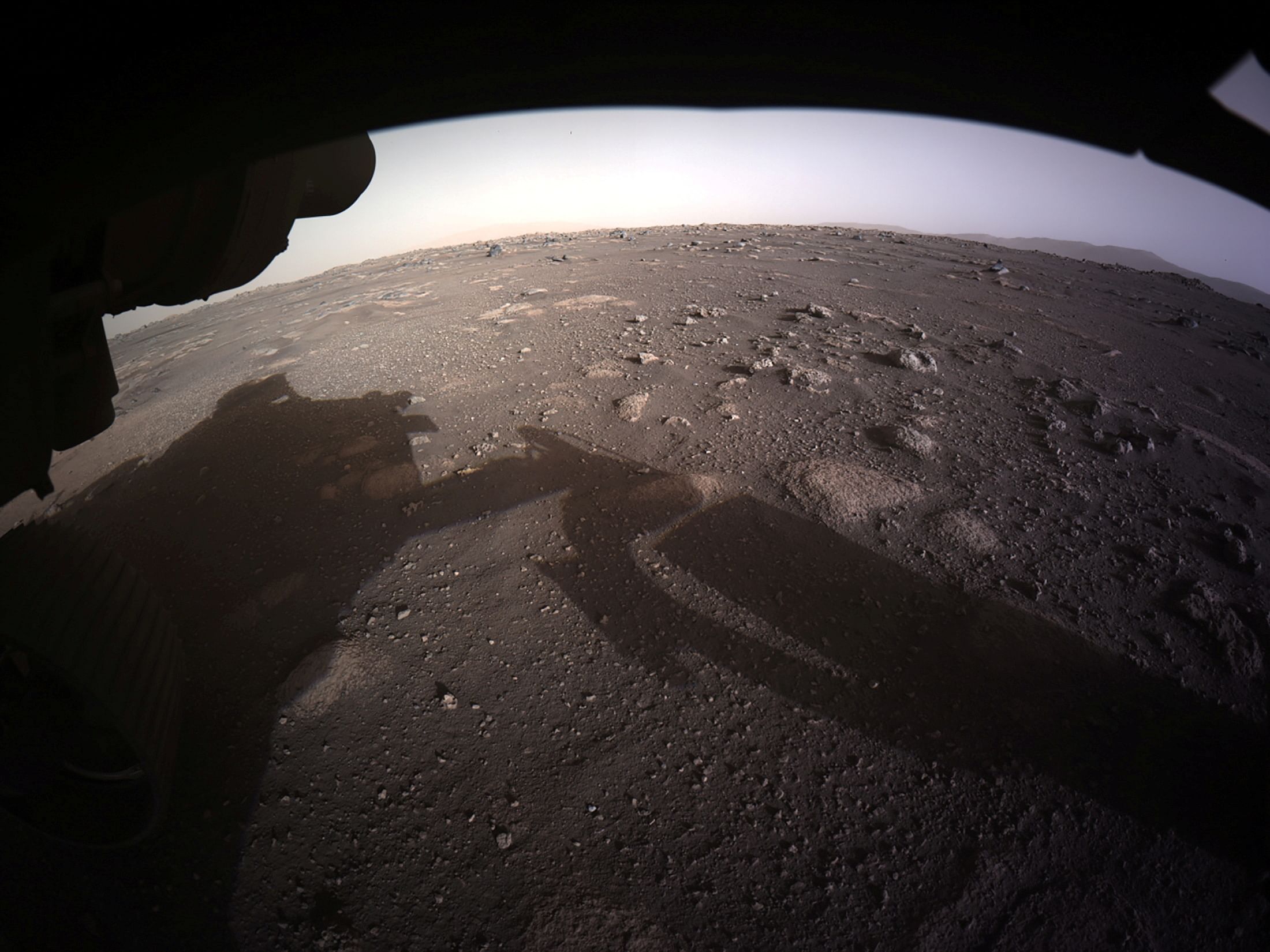 The first high-resolution, color image to be sent back by the Hazard Cameras (Hazcams) on the underside of NASA's Perseverance Mars rover is seen after its landing on Mars February 18, 2021. Credit: Reuters Photo