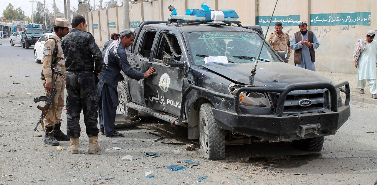 Security personnel inspect the site of a deadly roadside bomb in Helmand province, southern Afghanistan. Credit: AP Photo