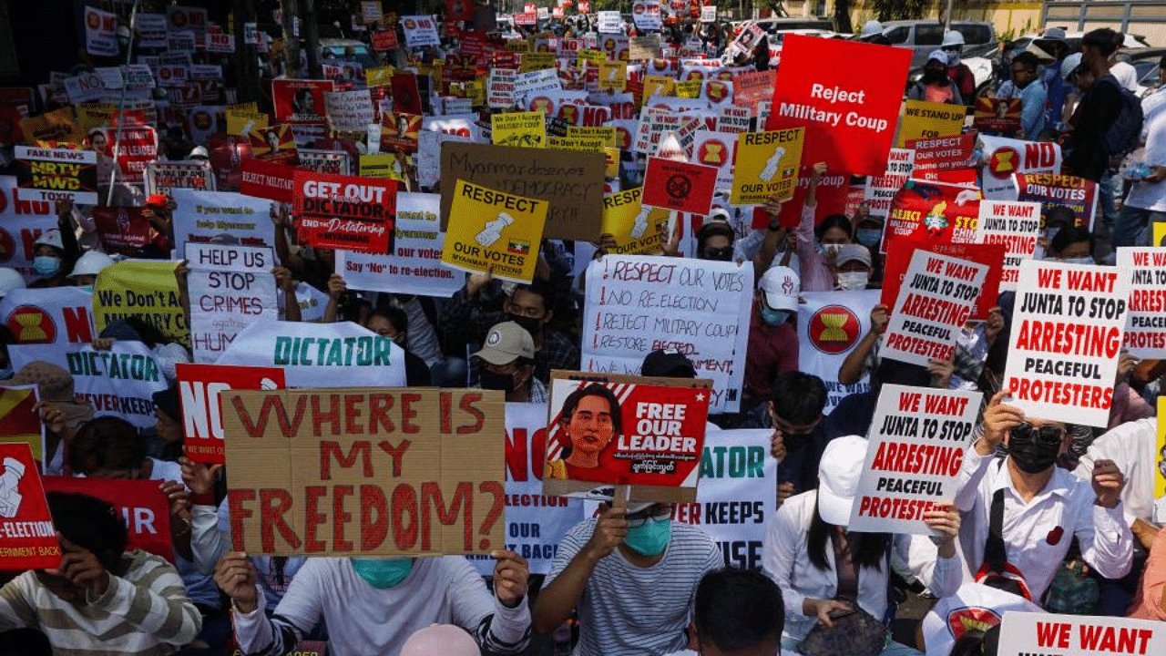 Protesters hold signs as they take part in a demonstration against the military coup in front of the Indonesian embassy in Yangon on February 24, 2021. Credit: AFP Photo