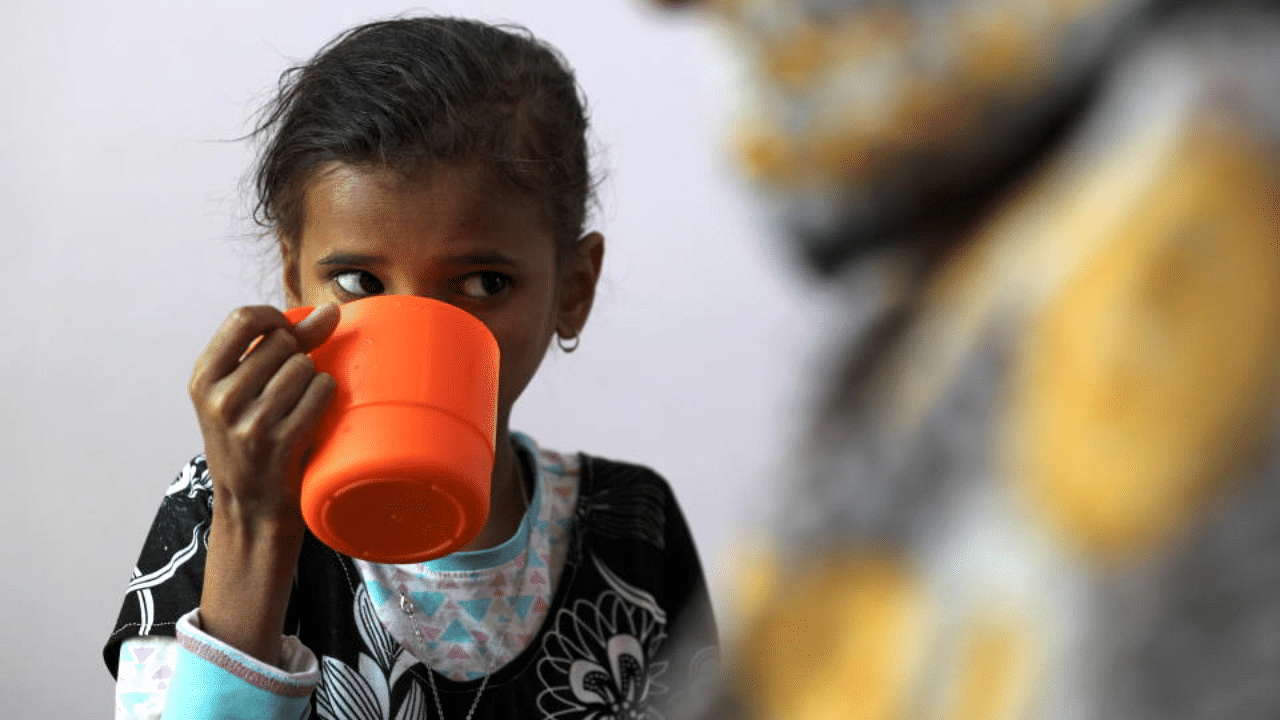 Ahmadiya Juaidi, 13, drinks a supplemental nutrition shake at malnutrition treatment ward of al-Sabeen hospital in Sanaa, Yemen February 24, 2021. Credit: Reuters Photo