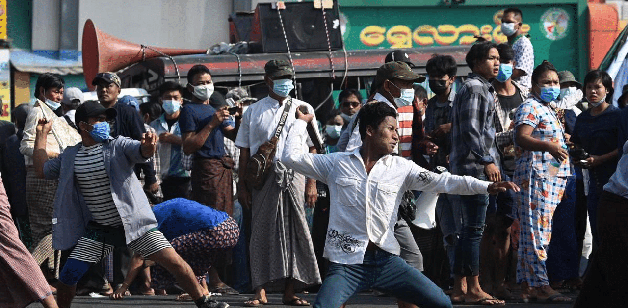 Pro-military supporters throw projectiles at residents in Yangon. Credit: AFP Photo