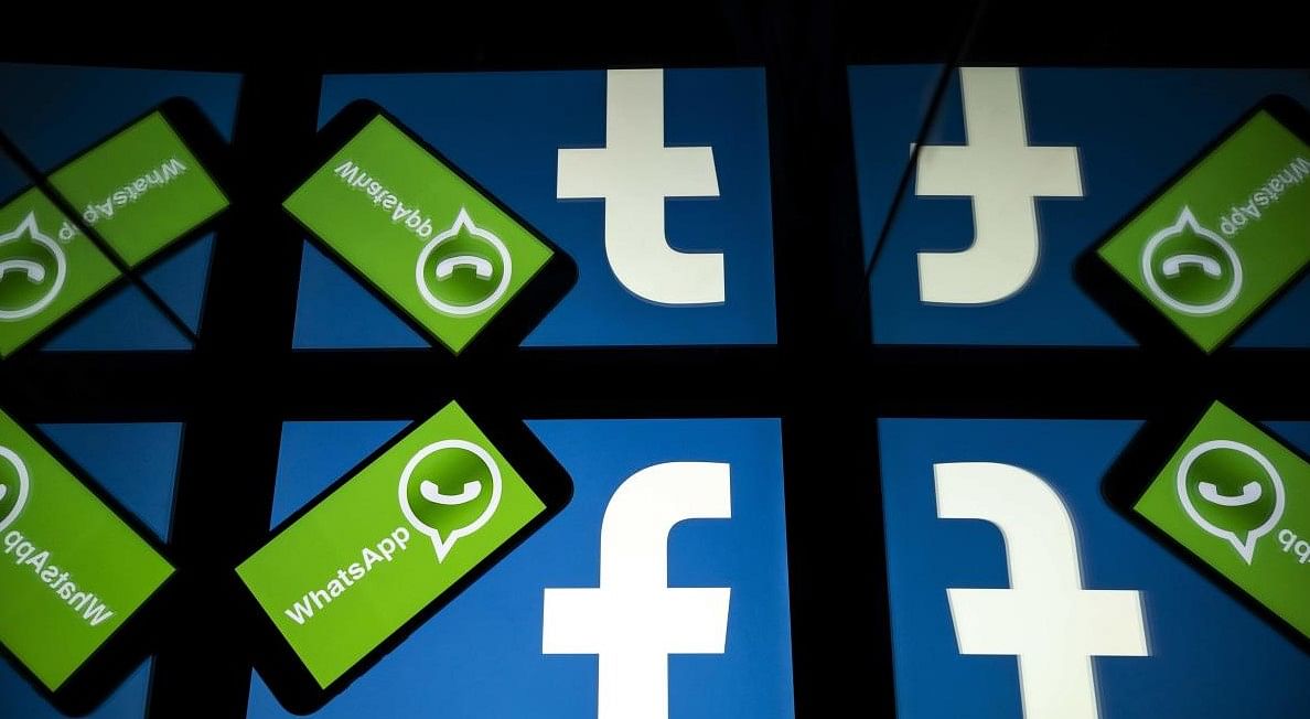 The logo of US social network Facebook and mobile messaging service WhatsApp are seen on the screens of a smartphone and a tablet. Picture Credit: Lionel BONAVENTURE / AFP