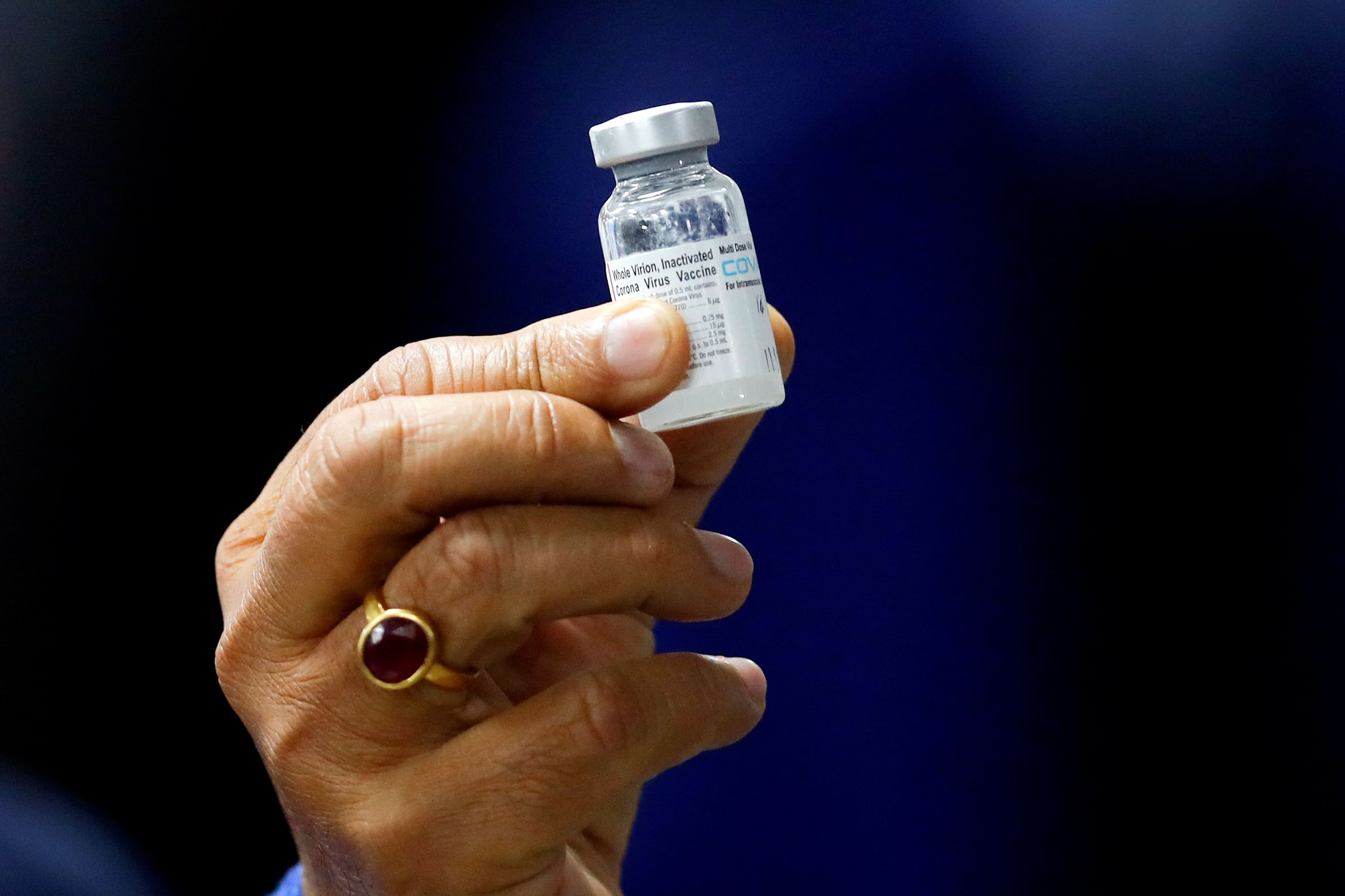 Union Health Minister Harsh Vardhan holds a dose of Bharat Biotech's Covid-19 vaccine called COVAXIN during a vaccination campaign at All India Institute of Medical Sciences (AIIMS) hospital in New Delhi, January 16, 2021. Credit: REUTERS File Photo