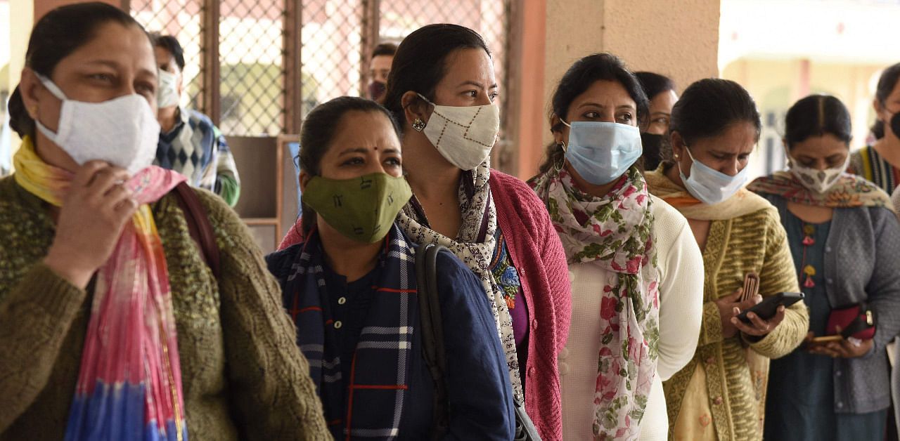 Teachers stand in a queue to get tested for the Covid-19 in Punjab. Credit: AFP Photo