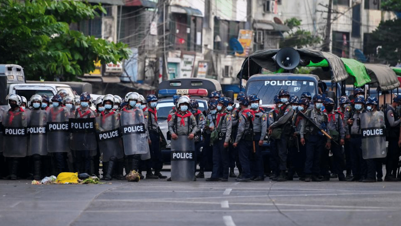 Police stand in formation on a road in a residential area in Yangon on February 25, 2021 following weeks of mass demonstrations against the military coup. Credit: AFP Photo