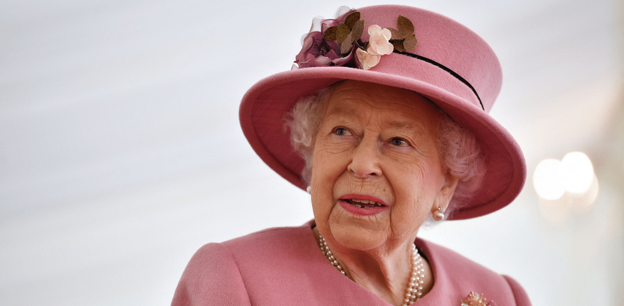Queen Elizabeth II speaks with staff during a visit to the Defence Science and Technology Laboratory. Credit: AFP Photo 
