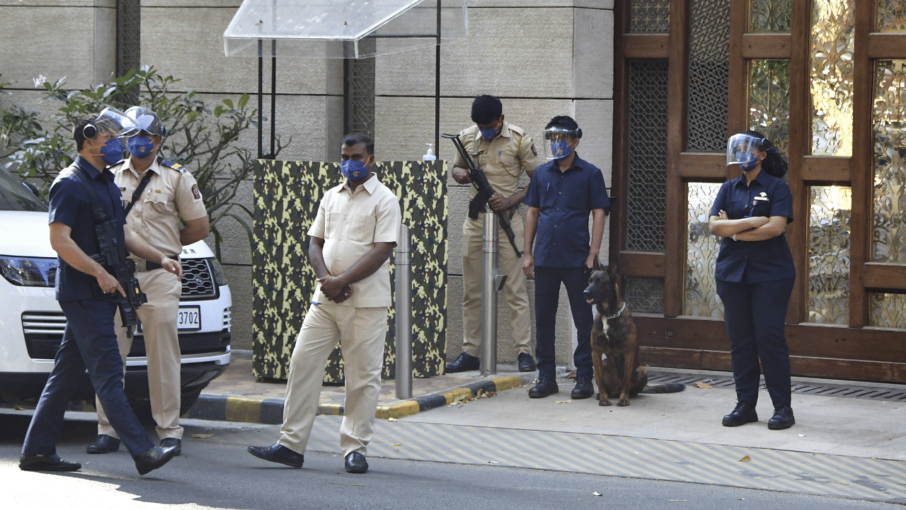 Police personnel guard outside industrialist Mukesh Ambani's residence Antilla, a day after explosives were found in an abandoned car in its vicinity. Credit: PTI Photo