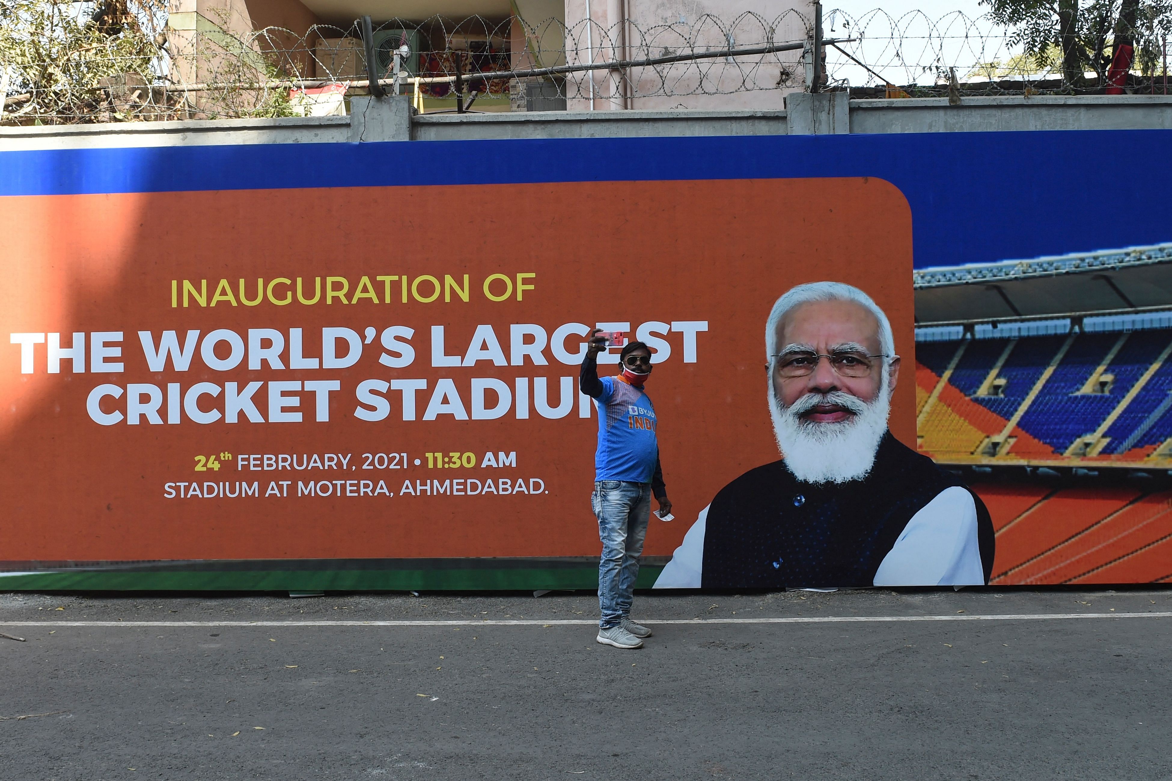 A Cricket fan takes a selfie picture in front of the newly named Naredra Modi Stadium, the world's biggest cricket stadium, on the first day of the third Test match between India and England, in Motera, on the outskirts of Ahmedabad on February 24, 2021. Credit: AFP Photo