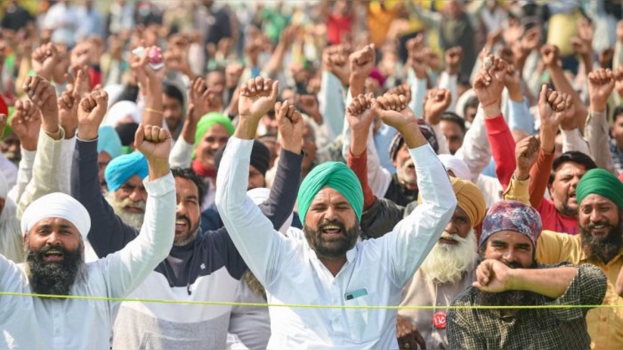 Farmers raise slogans during their protest against new farm laws, at Ghazipur border in New Delhi. Credit: PTI File Photo