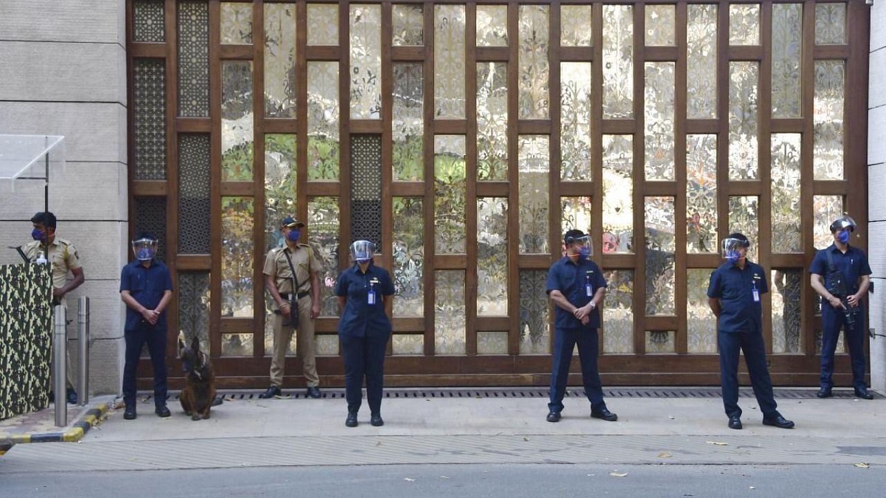 Police personnel guard outside industrialist Mukesh Ambani's residence Antilla, a day after explosives were found in an abandoned car in its vicinity, in Mumbai. Credit: PTI.