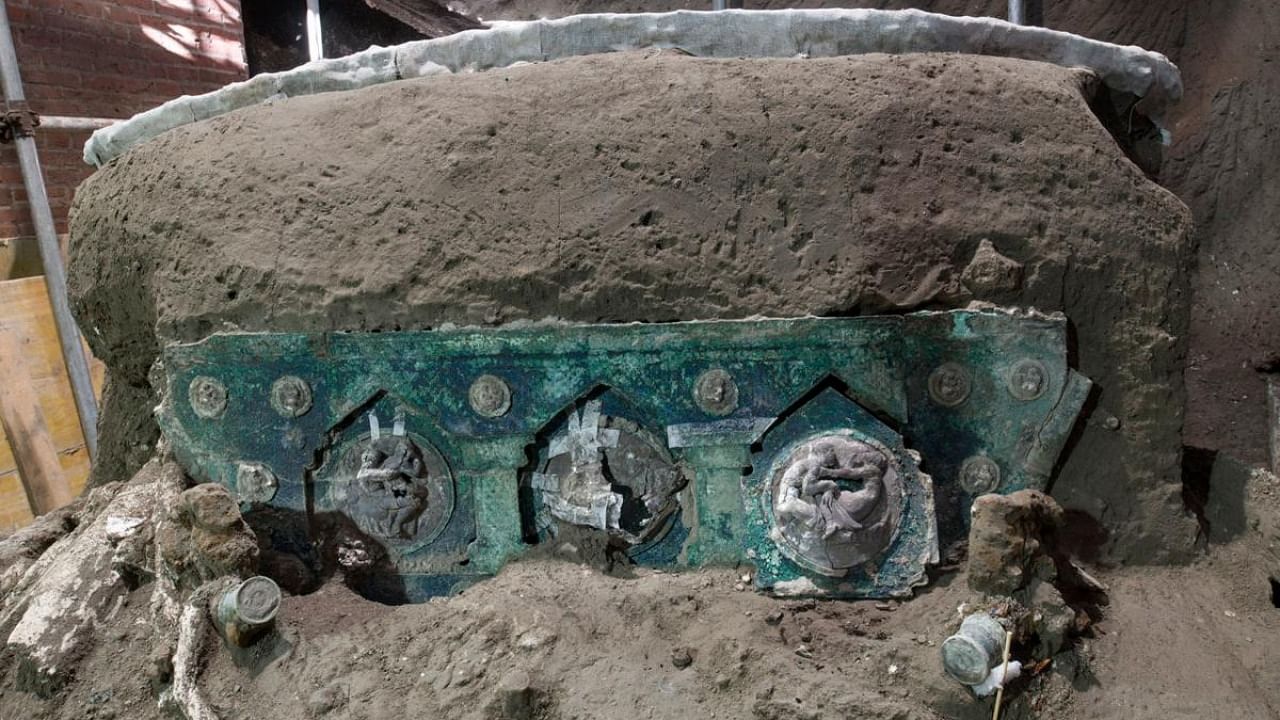A photo handout on February 27, 2021 by the archaeological park of Pompeii shows a detail of a large Roman four-wheeled ceremonial chariot after it was discovered near the The archaeological park of Pompeii. Credit: AFP/Pompeii Archaeological Park/Handout.