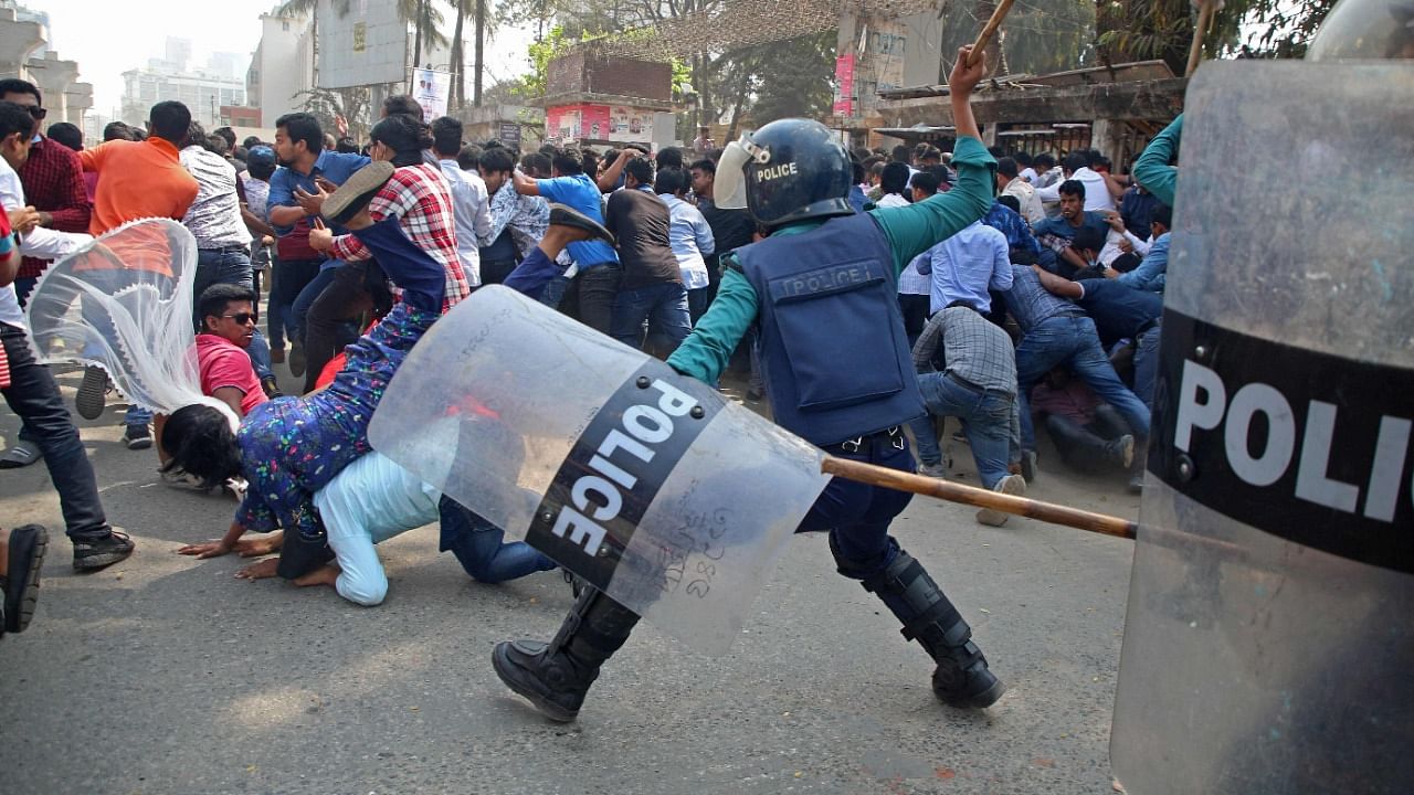 Policemen clash with the activists of Bangladesh Nationalist Party (BNP) during the third day of protests following the death of Mushtaq Ahmed, a prominent writer and government critic in jail. Credit: AFP Photo